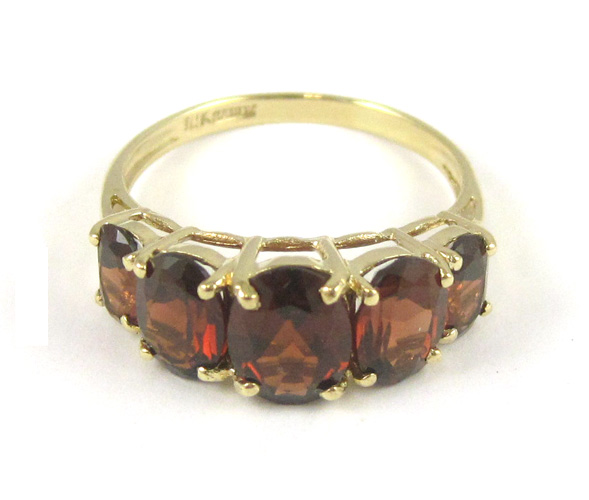 Appraisal: GARNET AND TEN KARAT YELLOW GOLD RING set with five