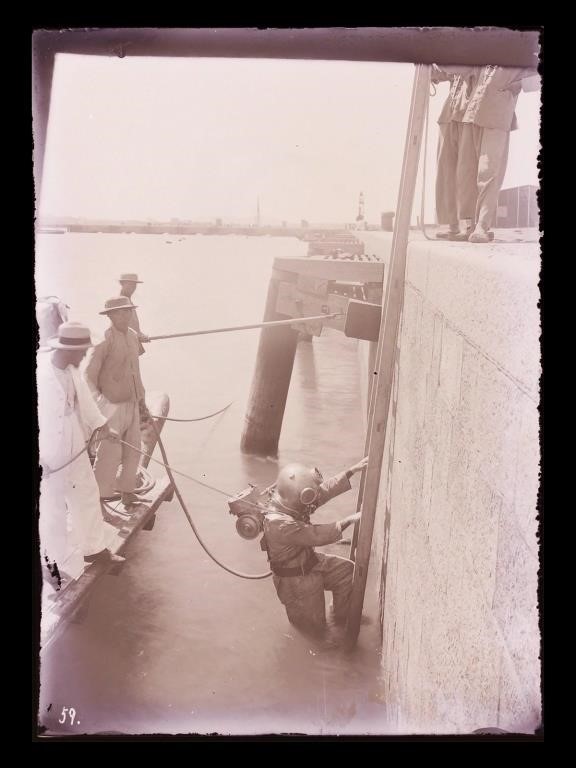 Appraisal: Circa glass negative of Chinese workers helping diver on port