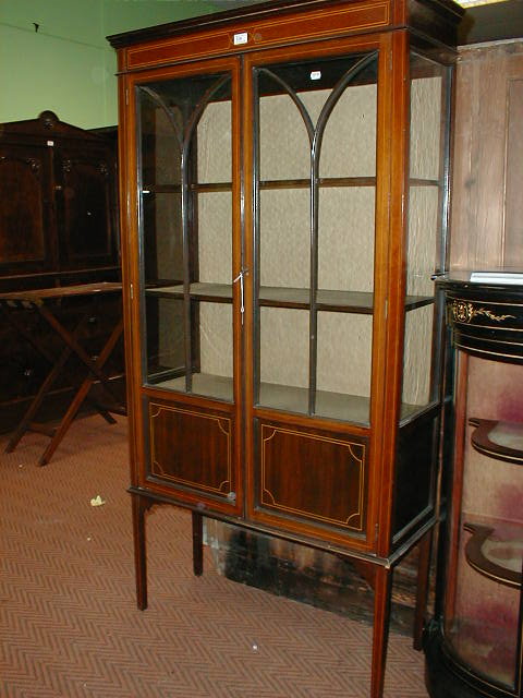 Appraisal: An Edwardian string inlaid mahogany display cabinet with two astragal