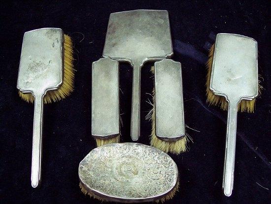 Appraisal: An engine turned silver backed dressing table set and an