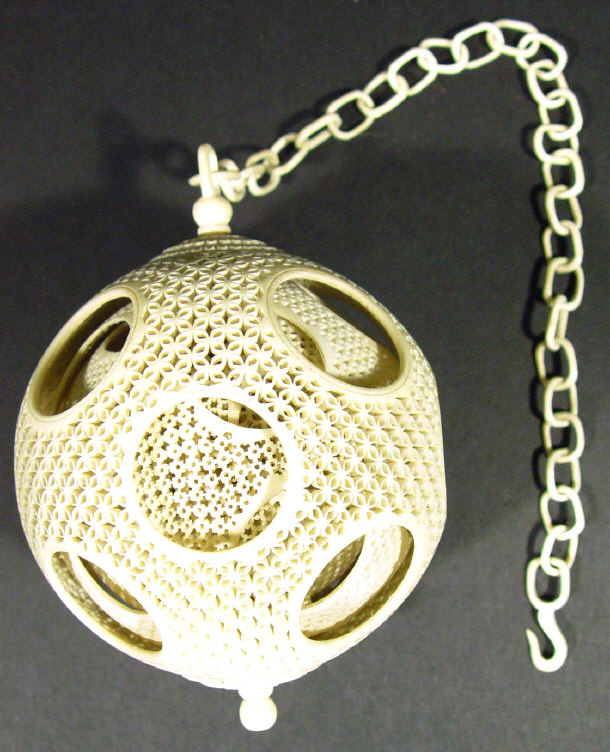 Appraisal: Oriental ivory puzzle ball pierced with flower heads and hanging