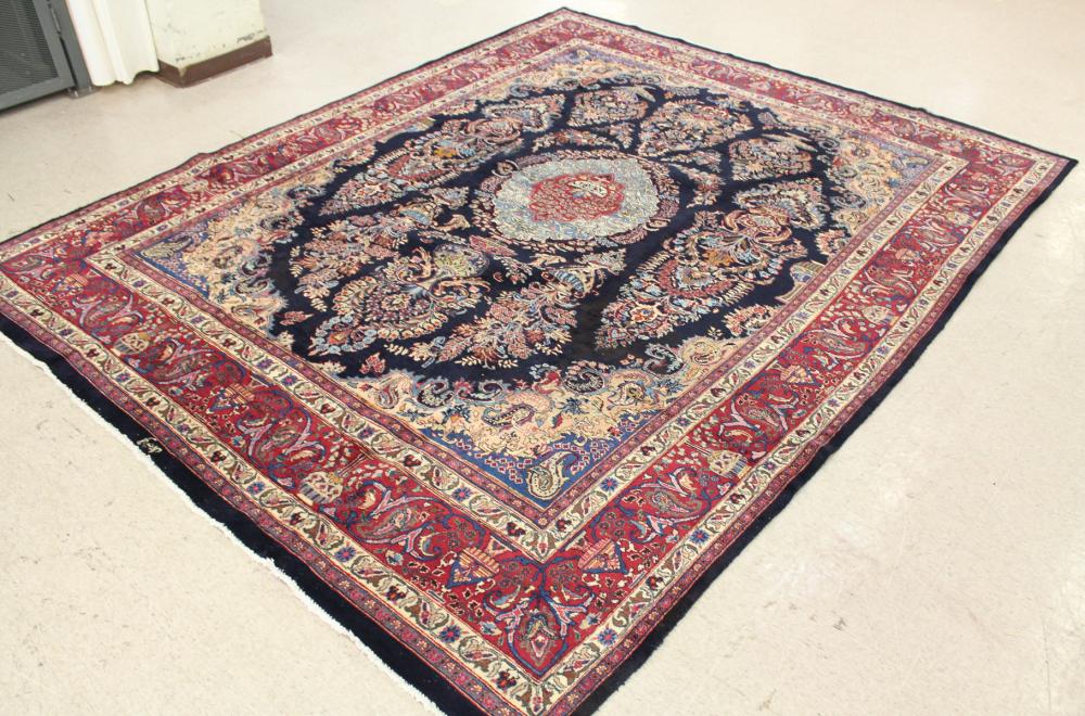 Appraisal: SIGNED HAND KNOTTED PERSIAN CARPET floral and central floral medallion