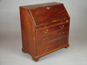 Appraisal: A George III mahogany and walnut slope front writing bureau