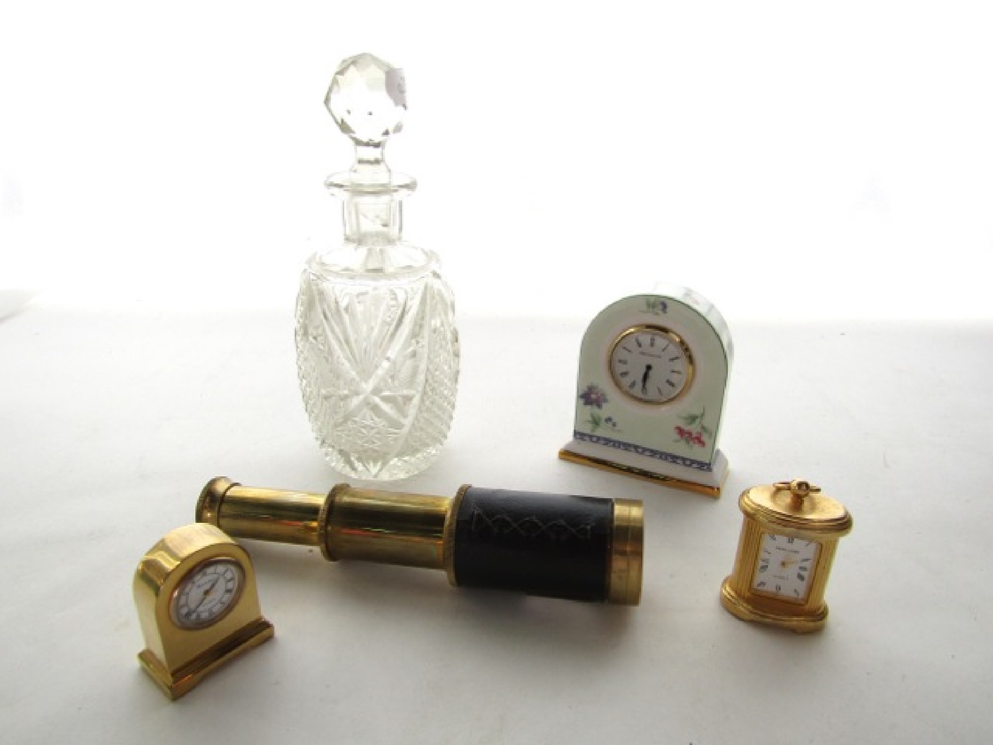 Appraisal: A two draw pocket telescope a tiny carriage clock another