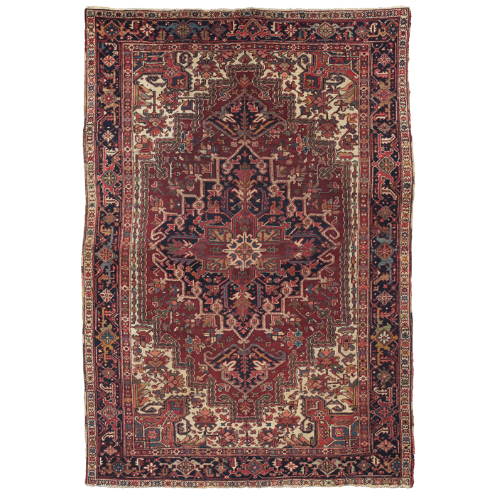 Appraisal: Persian Heriz rug c stylized floral design on a red