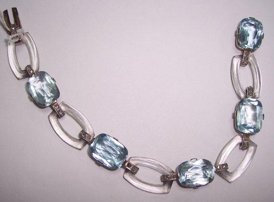 Appraisal: A bracelet of alternating aquamarine set and translucent resin links