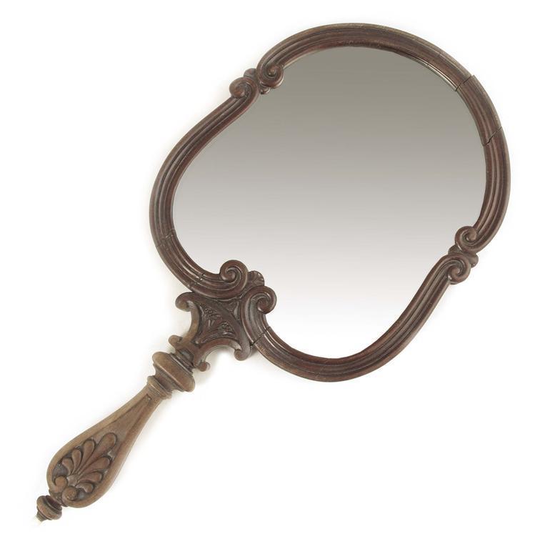 Appraisal: A late th century carved mahogany hand mirror