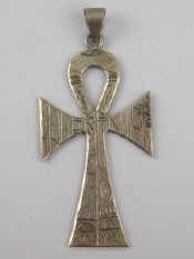 Appraisal: A white metal tests silver cross pendant with engraved decoration