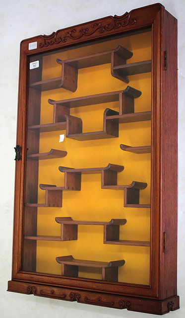 Appraisal: A CHINESE HARDWOOD WALL HANGING DISPLAY CABINET the glazed door