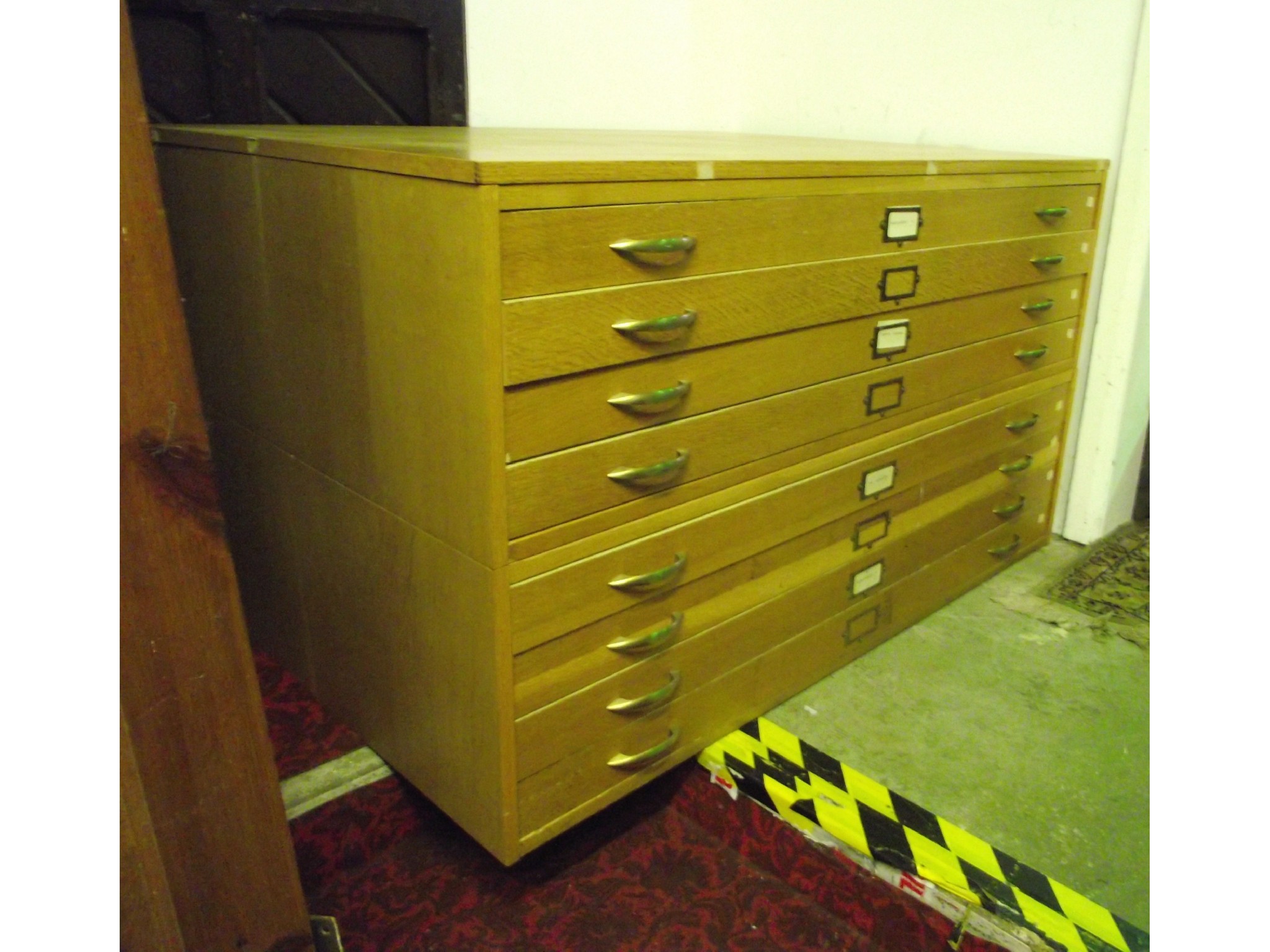 Appraisal: A light oak veneered two sectional plan chest fitted with