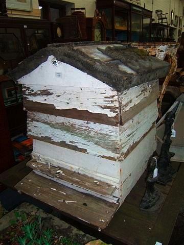 Appraisal: A white painted bee hive with pitched roof high