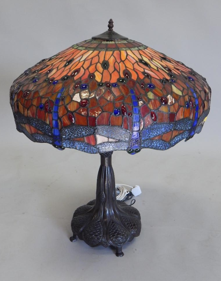 Appraisal: A bronzed Tiffany style lamp the stained glass shade decorated