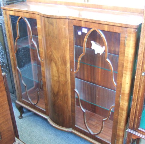 Appraisal: A 's walnut display cabinet with bowed central section and