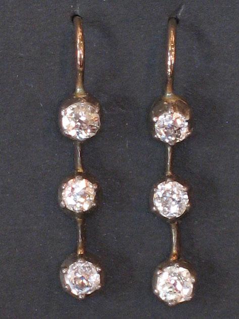 Appraisal: A PAIR OF DIAMOND EARRINGS set as a train of