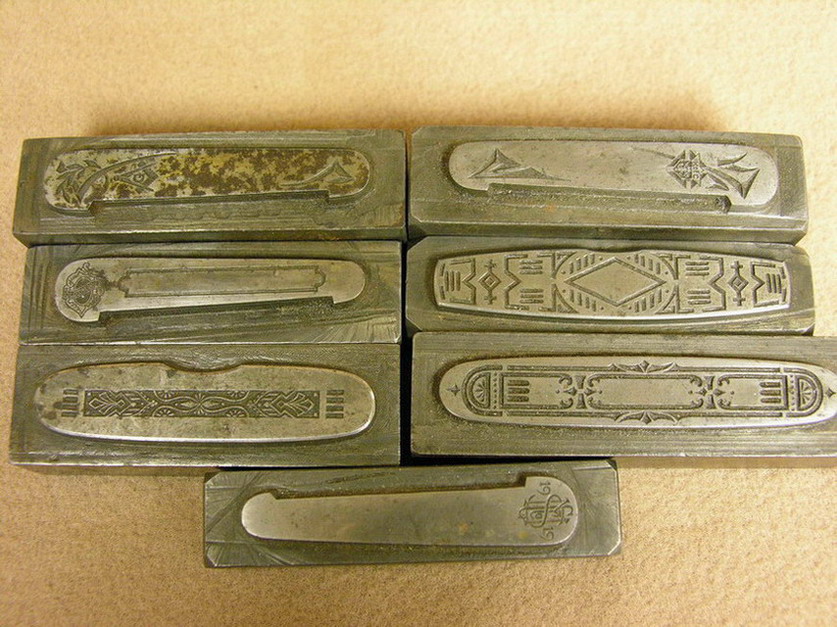 Appraisal: SEVEN VINTAGE POCKET KNIFE DIES Steel dies for pressing sterling