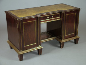 Appraisal: A mahogany and brass bound kneehole desk early th century