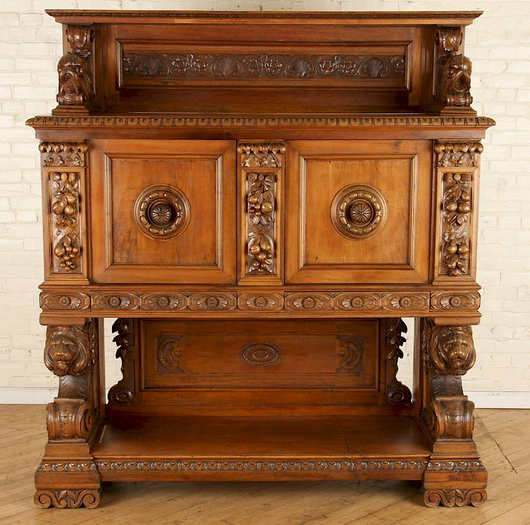 Appraisal: CONTINENTAL WALNUT CUPBOARD LION CARVED SUPPORTS A Continental walnut two