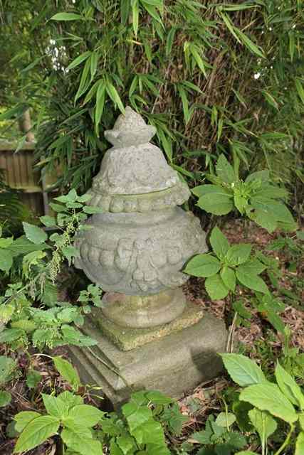 Appraisal: A RECONSTITUTED STONE FINIAL with pointed top and ovoid body