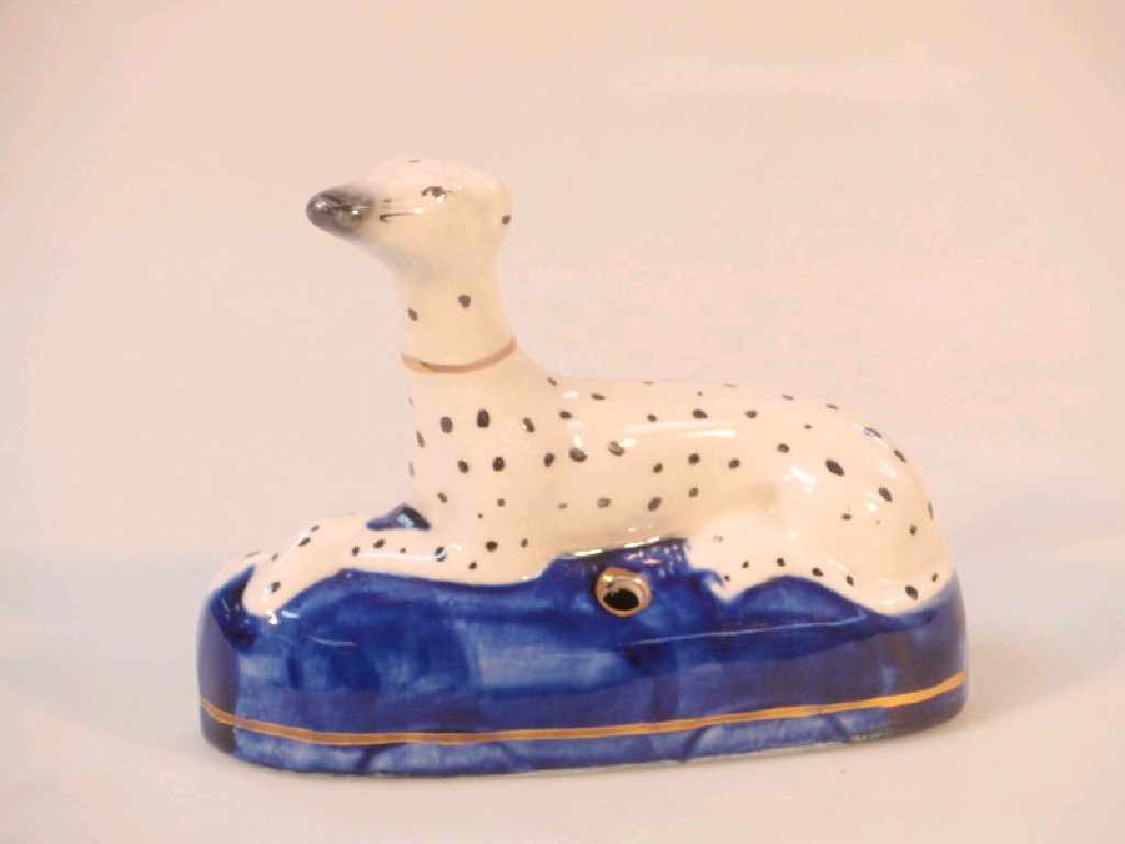 Appraisal: A thC Staffordshire pottery quill stand modelled as a recumbent