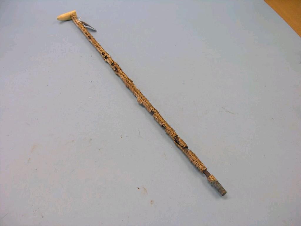 Appraisal: A fish vertebrae walking cane with marine ivory tooth handle