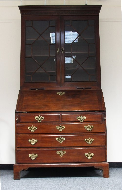 Appraisal: A George III mahogany bureau bookcase the moulded cornice above