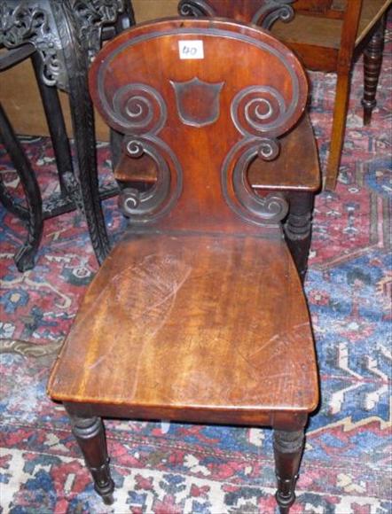 Appraisal: A pair of Victorian carved mahogany hall chairs