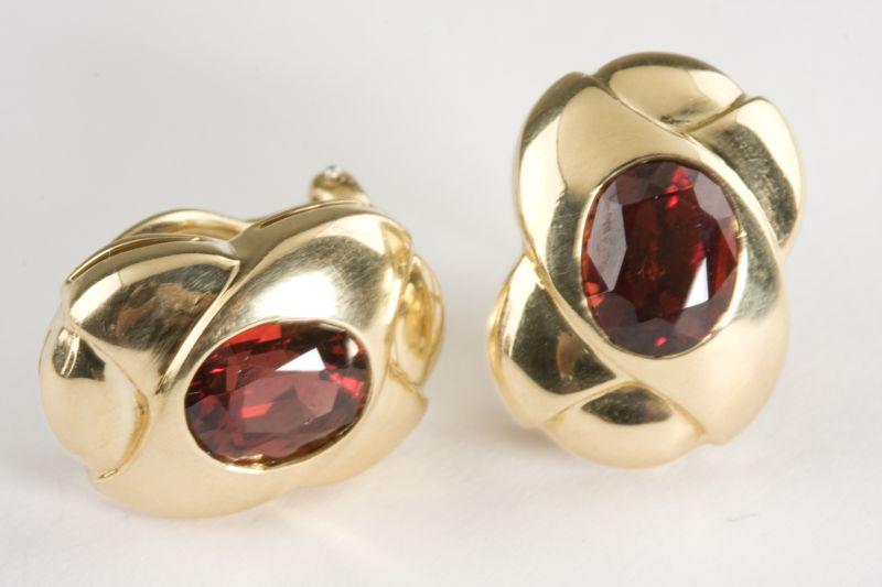 Appraisal: KT and Garnet Earclips by Gucci each simply set with