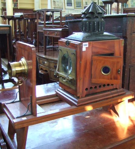 Appraisal: A mahogany and brass mounted scientific magic lantern by Newton