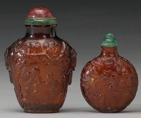 Appraisal: Two amber snuff bottles th Century The first a large