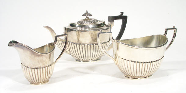 Appraisal: Three piece silver plated teaset of fluted form the teapot