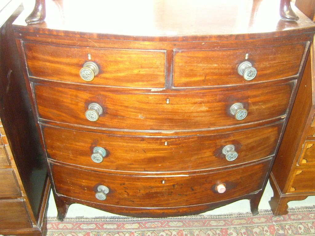 Appraisal: A Georgian mahogany bow front chest of long and short