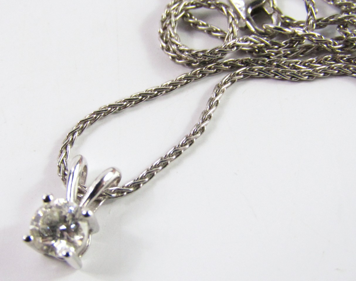 Appraisal: A single stone diamond set pendant in platinum upon a