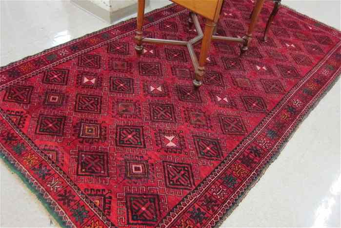 Appraisal: PERSIAN TURKOMAN CARPET featuring a red field completely covered in