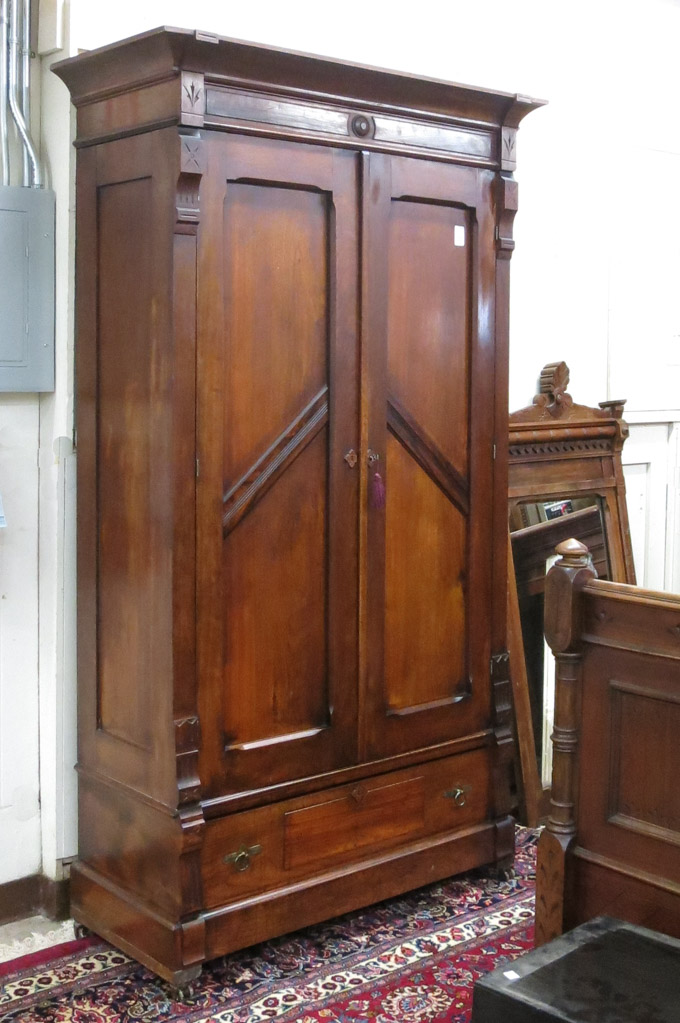 Appraisal: A VICTORIAN WALNUT DOUBLE-DOOR WARDROBE Eastlake style American c having