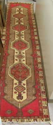 Appraisal: PERSIAN SERAB RUNNER four geometric medallion design and floral border