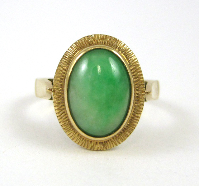 Appraisal: GREEN JADE AND FOURTEEN KARAT GOLD RING set with an