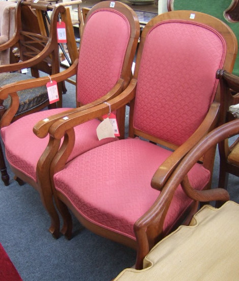 Appraisal: A pair of th century walnut framed fauteuils with hooped