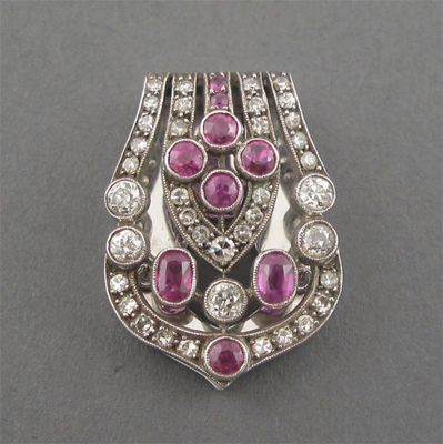 Appraisal: A ruby and diamond set white gold clip of buckle