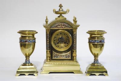 Appraisal: A FRENCH CLOCK GARNITURE the twin barrel movement striking on