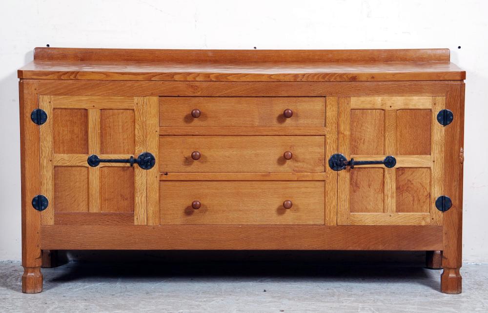 Appraisal: AN ADZED OAK SIDEBOARD by Robert Mouseman Thompson of oblong