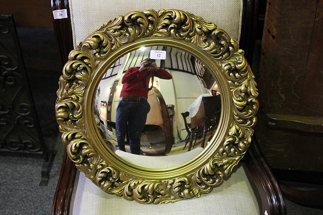 Appraisal: A GILT PLASTER CONVEX MIRROR with foliate frame cm diameter