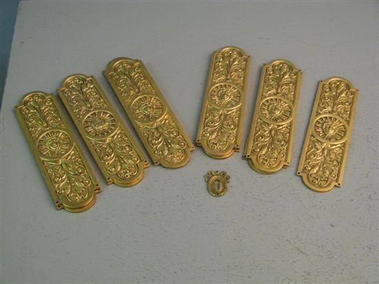 Appraisal: Eleven matching gilt metal door pushes embossed with masks each