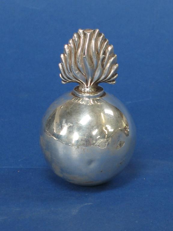 Appraisal: A TABLE LIGHTER of circular form with detachable flame-shaped wick