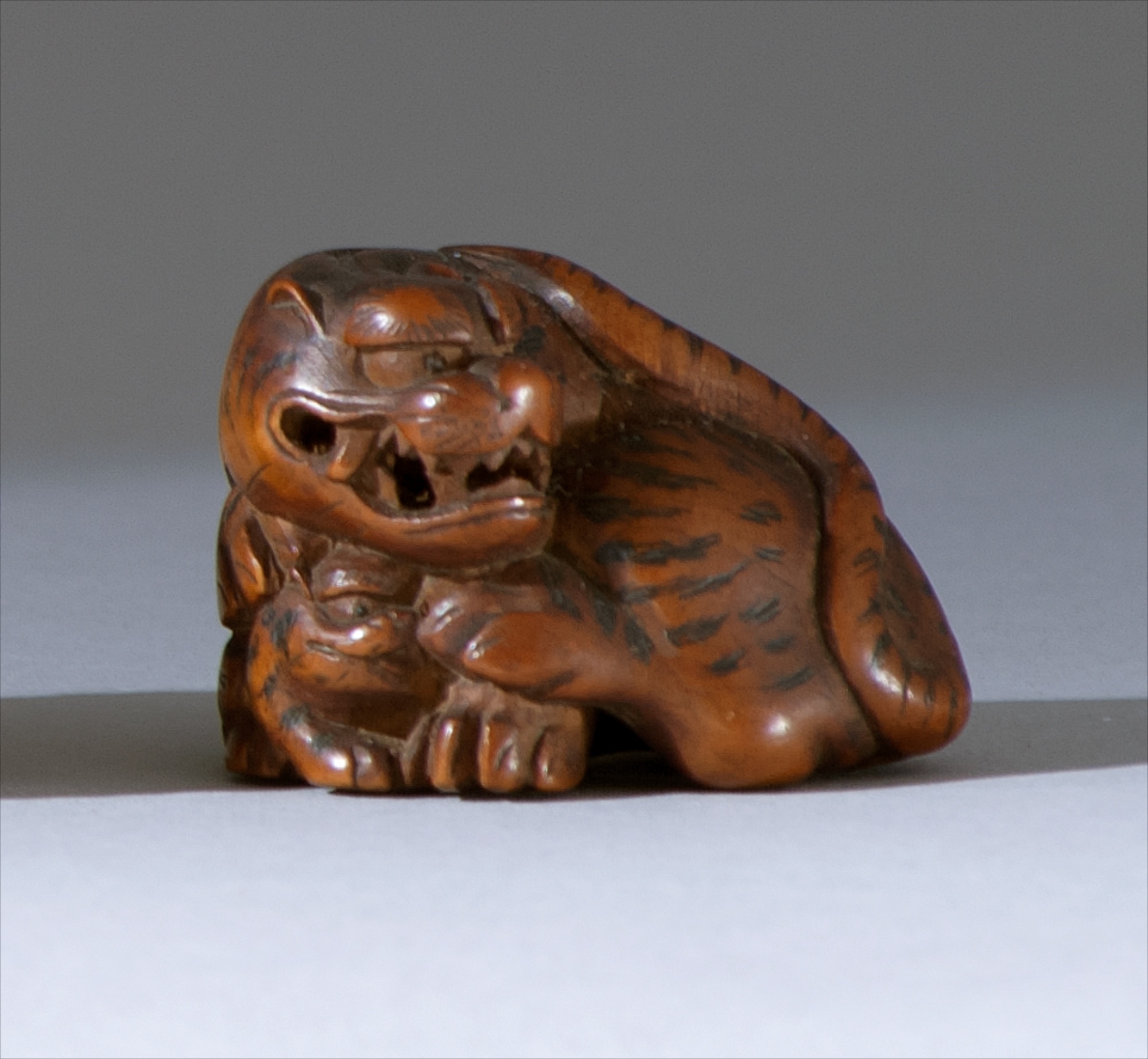 Appraisal: WOOD NETSUKE th CenturyBy Yaokichi Masayoshi A tiger guarding its