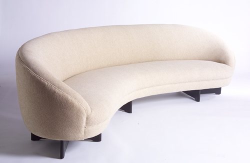 Appraisal: VLADIMIR KAGAN Curved sofa upholstered in textured cream-colored wool with