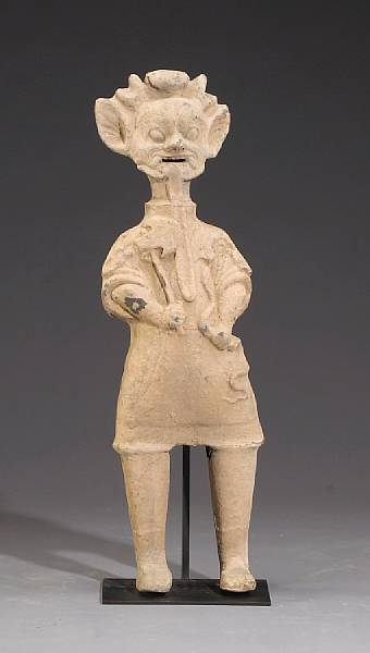 Appraisal: A molded pottery mortuary figure of a demon Han Dynasty