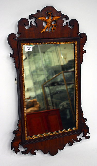 Appraisal: A GEORGIAN STYLE MAHOGANY FRET FRAMED WALL MIRROR with Hoho