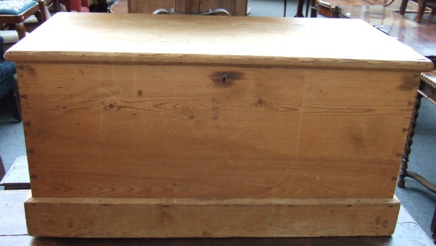 Appraisal: A pine trunk with wrought iron carry handles and visible