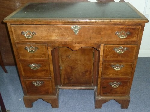 Appraisal: A Queen Anne style walnut kneehole desk with leather inset