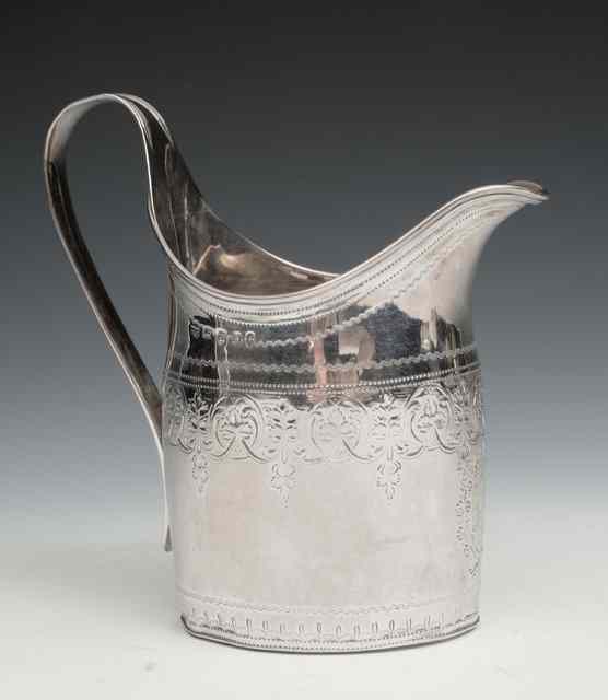 Appraisal: A GEORGE III SILVER HELMET SHAPED CREAM JUG with reeded